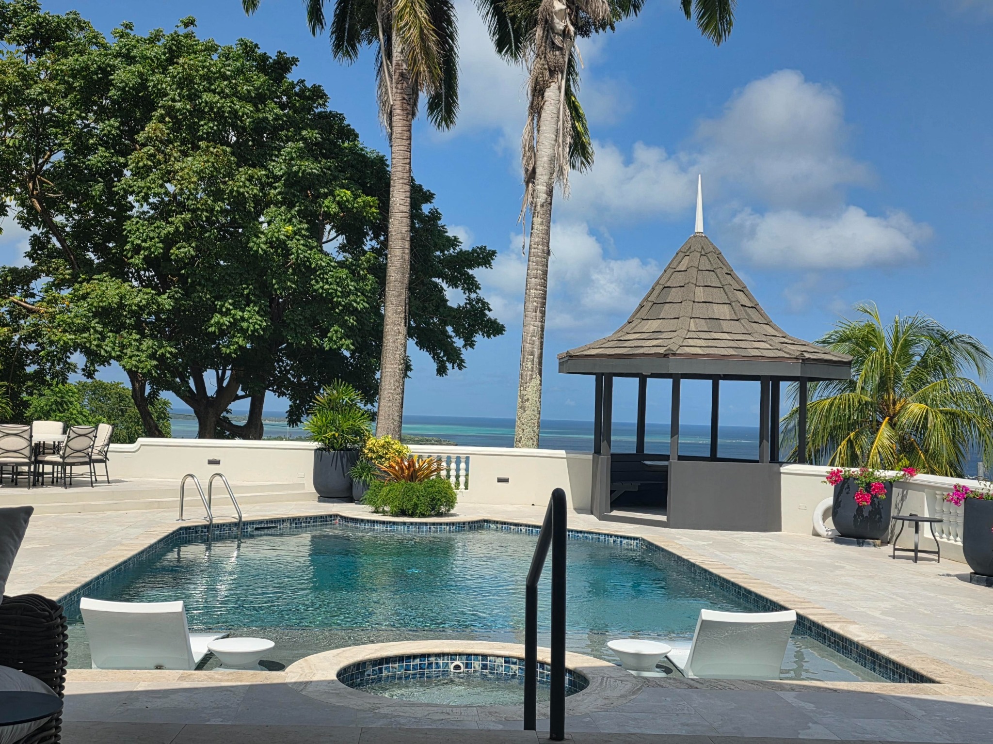 Sol Y Mar pool and cabana with palms and a sweeping Caribbean Sea view