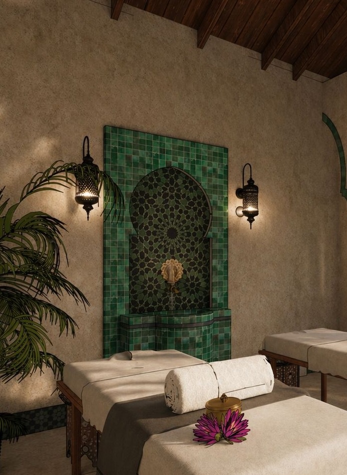 Green Moroccan tile fountain and side-by-side massage tables in the private spa